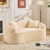 Beige curved two - person compress sofa. It has armrests on both sides, comes with two pillows, is suitable for small - sized apartments